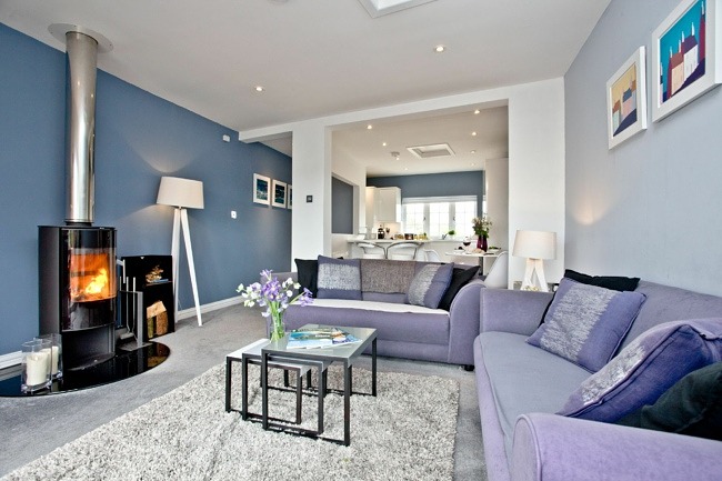 Cosy lounge with wood burner, sofa and coffee table in - Blue Bay