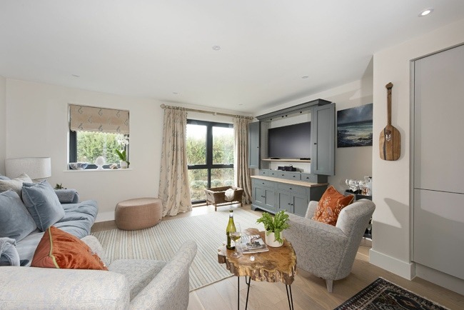 Open plan living  space with a Tv and seating for all guests - Harlyn Folly