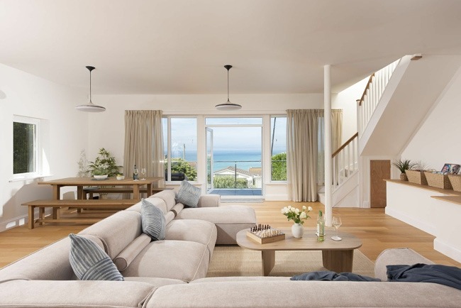 Large living space with balcony and seating area, games table, TV and access to first floor - Pentire Beach House