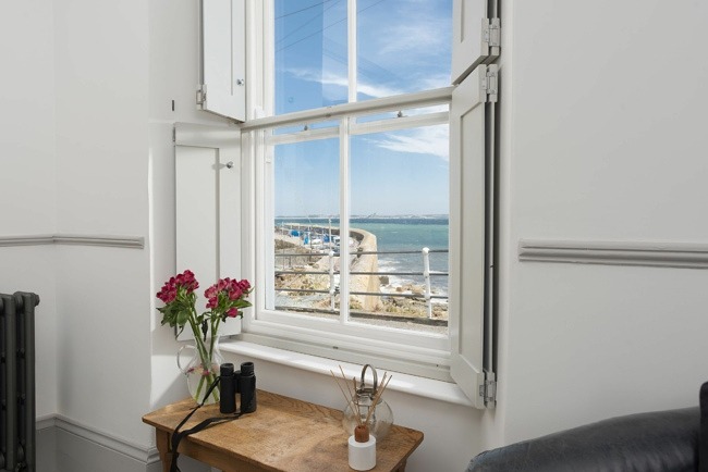 Ocean and harbour view from window side table and chair  - Glas Mor 
