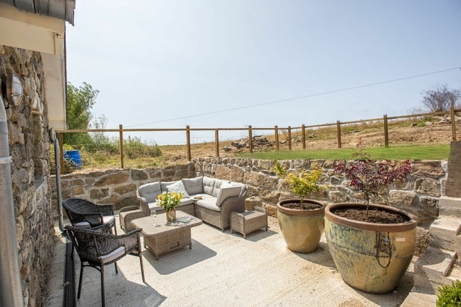 Garden with patio seating and grass area accessed by steps - Cuthberts Barn