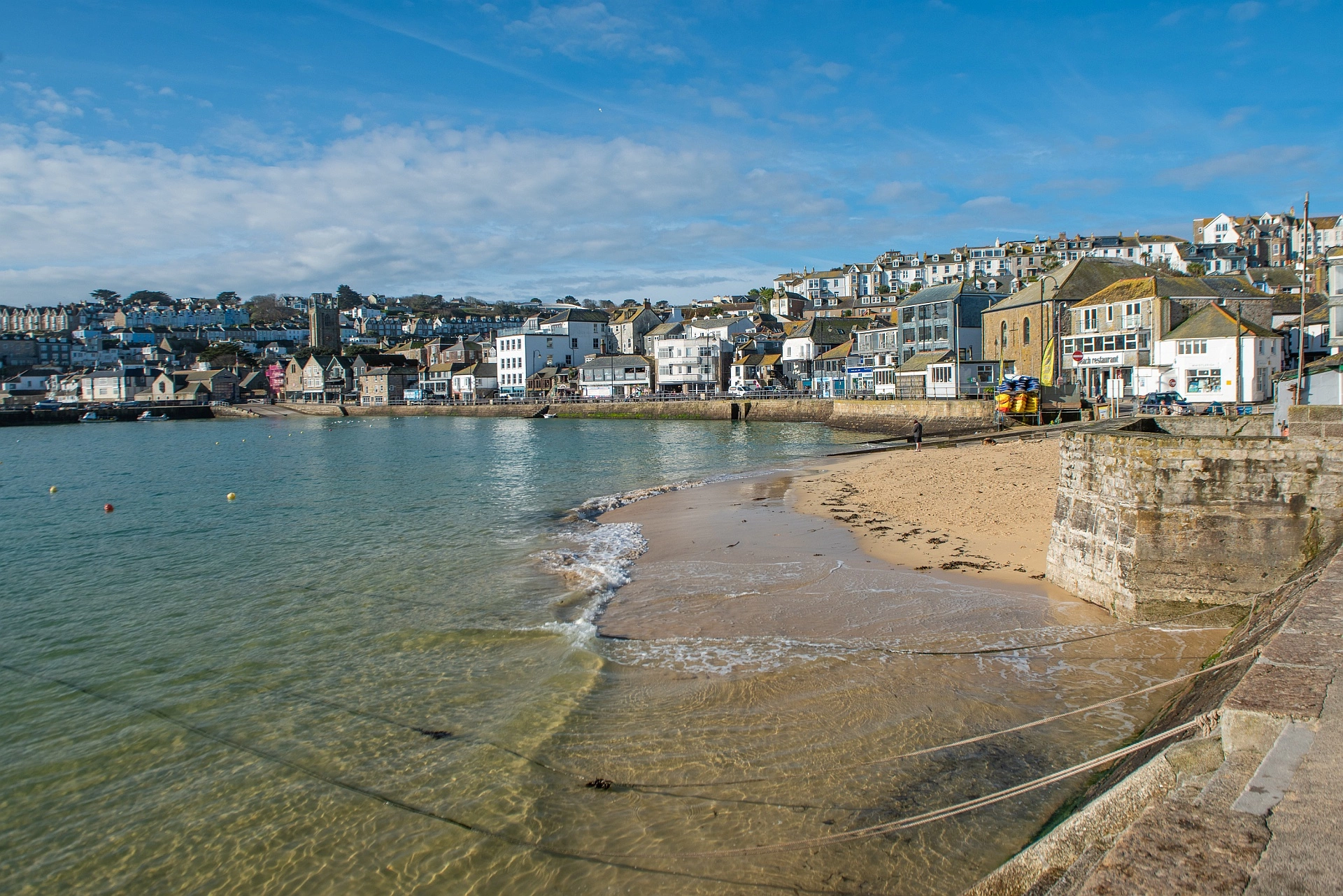 View across St Ives, Cornwall harbour and beach with the seafront and restaurants