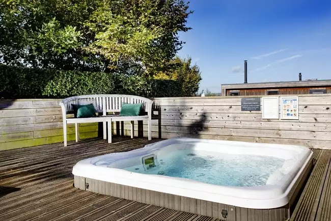 Hot tub sunk into decking with outdoor seating - The Sleights, Strawberryfield Park