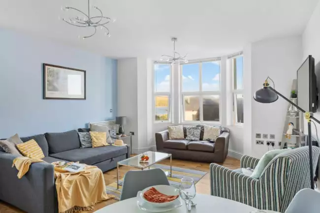 Lounge with plenty of seating, TV and large windows with sea view - 10 At The Beach