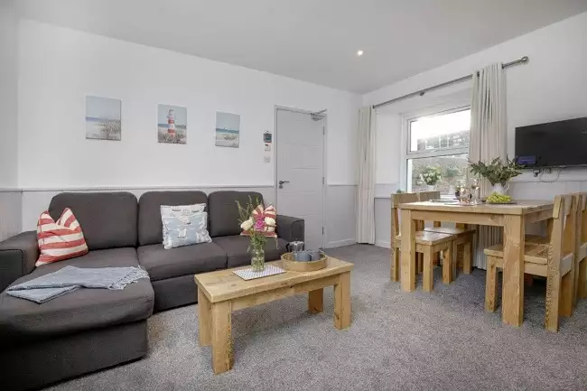 Light and airy living area leading to kitchen - Anchors Away
