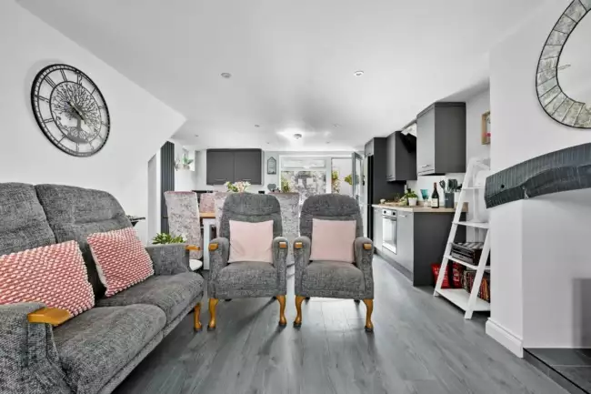 Living room with sofas and armchairs open plan with kitchen - Lilly's Cottage