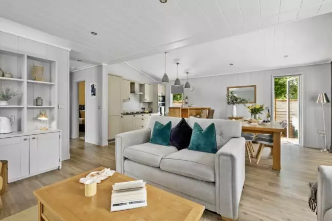 Living space with sofa, access to garden area and kitchen - The Retreat 