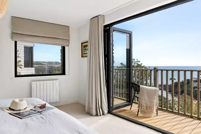 Bi-fold doors opening onto balcony from the master bedrom - Murrawingi